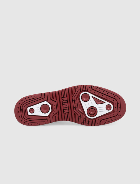 Red and white sneaker sole showing detailed traction pattern and PUMA logo on a white background