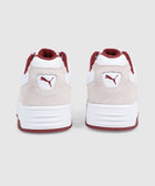 Back view of white and beige suede sneakers with red accents and Puma logo