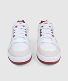 White low-top men's sneakers with red accents and suede toe, streetwear style