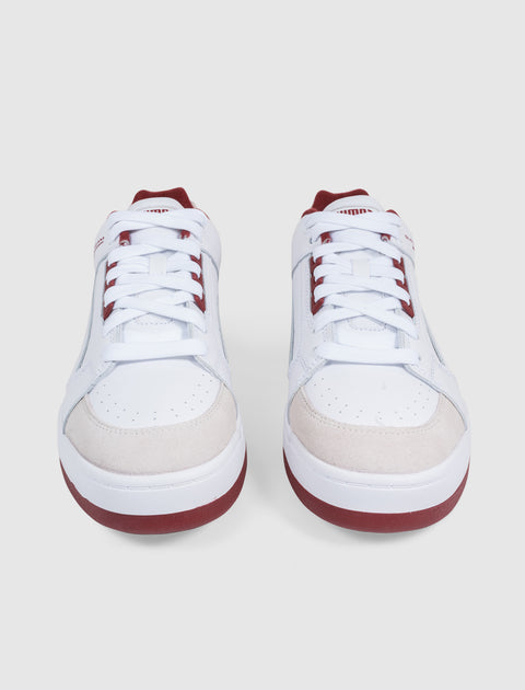 White low-top men's sneakers with red accents and suede toe, streetwear style