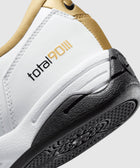 Close-up of white, gold, and black sneaker heel with Total 90 logo and textured sole