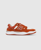 Rust orange and white suede mesh sneaker with side N logo on white background