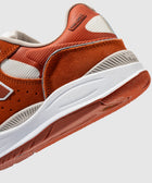 Close-up of orange and white men's streetwear sneaker with suede and mesh details