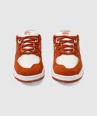 Pair of rust and white suede sneakers with mesh panels, front view, on light background