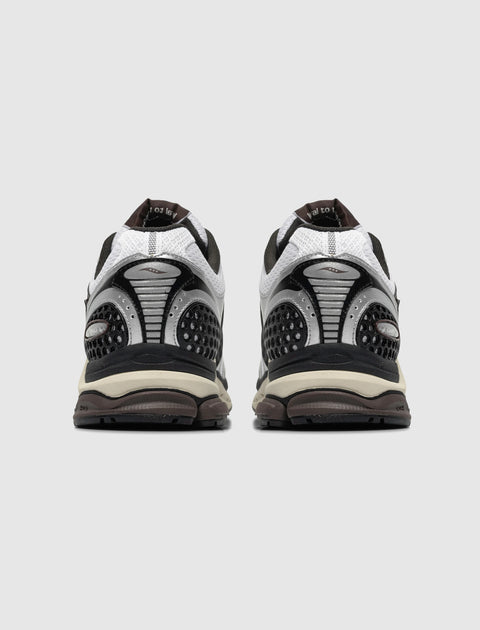 Rear view of white and black athletic sneakers with mesh and textured detailing