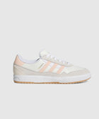 White and blush pink low-top sneaker with suede details and gum sole, side profile view.