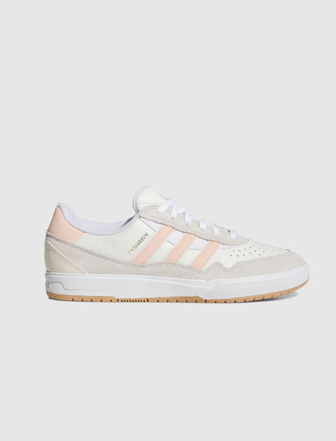 White and blush pink low-top sneaker with suede details and gum sole, side profile view.