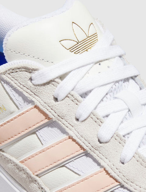 White and pink suede streetwear sneaker with gold logo and textured detailing
