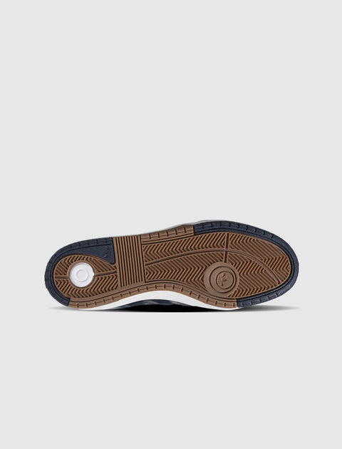 Navy, brown, and white sneaker outsole with herringbone tread pattern on white background.