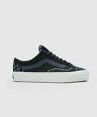 Men's low-top sneaker with black and green cheetah pattern and white sole on white background