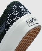 Close-up of sneaker heel with black and white woven pattern and rubber waffle outsole