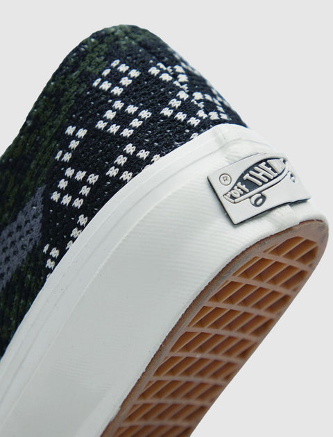 Close-up of sneaker heel with black and white woven pattern and rubber waffle outsole