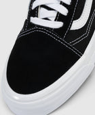 Black and white skate shoe close-up with white laces and rubber sole
