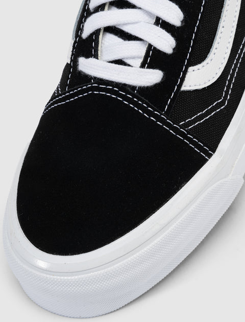 Black and white skate shoe close-up with white laces and rubber sole