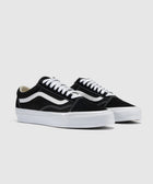 Black and white low-top sneakers with white laces and signature side stripe