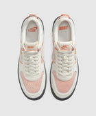 Top view of white and orange mesh low-top sneakers with Nike and UNION branding
