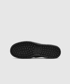 Black sneaker outsole with square grippy tread pattern on a plain background