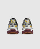 Rear view of metallic silver and yellow sneakers with maroon soles on a white background