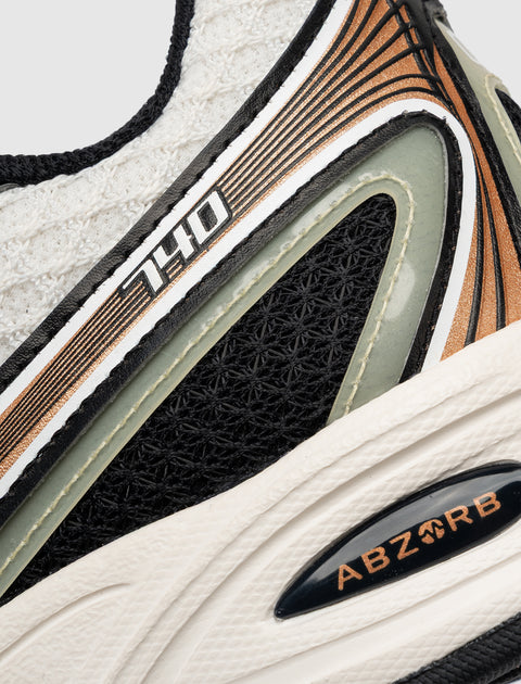 Close-up of sneaker with 740 and ABZORB details, black mesh and white textured sole