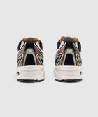 Rear view of men's multicolor athletic sneakers with abstract heel design on white background.