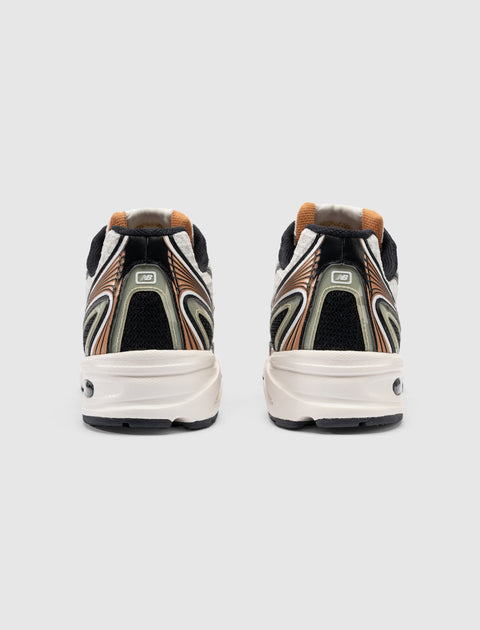 Rear view of men's multicolor athletic sneakers with abstract heel design on white background.