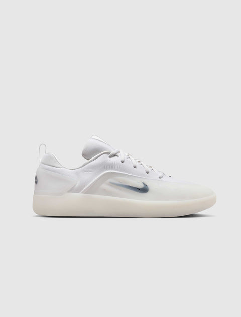 White low-top sneaker with translucent sole and swoosh logo, men's streetwear footwear