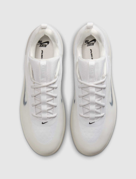 Top view of white mesh lace-up sneakers with translucent sole and black logo accents