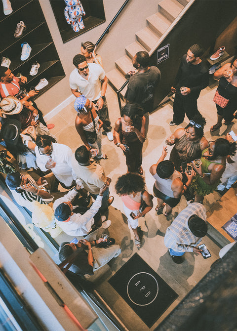 Top view of diverse crowd at a streetwear sneaker store event, people mingling indoors