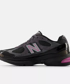 Black and grey mesh athletic sneaker with pink accents and reflective side logo