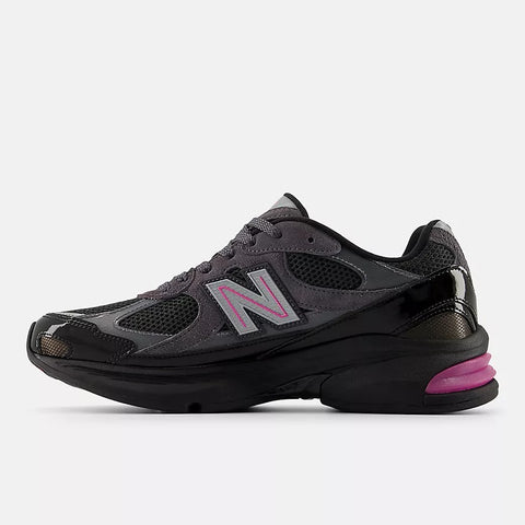 Black and grey mesh athletic sneaker with pink accents and reflective side logo