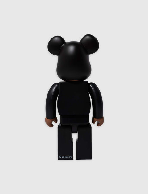 Back view of a black bear-shaped collectible toy figure on a plain white background