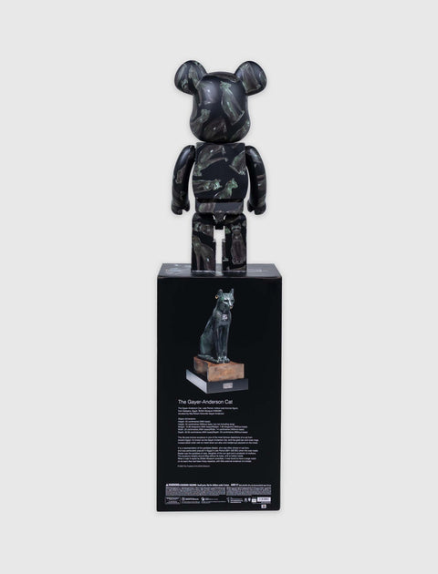 Black designer bearbrick figure with green cat art, standing on display box featuring Gayer-Anderson Cat