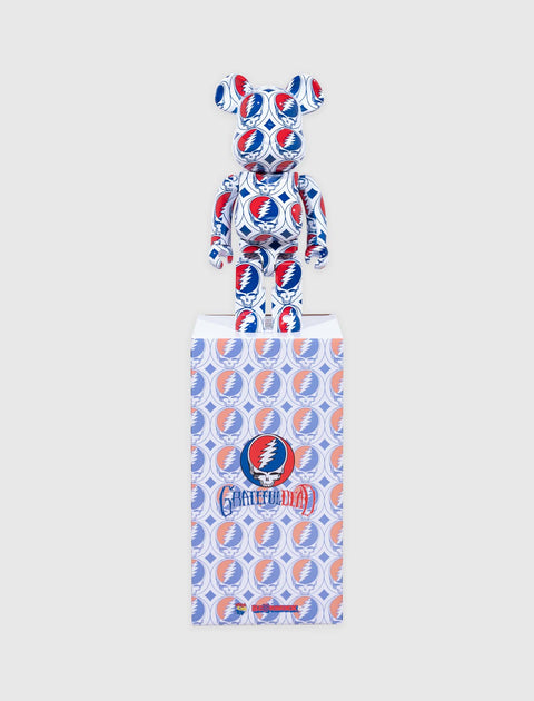 Bearbrick figurine with all-over Grateful Dead lightning skull pattern in red, blue, and white, displayed on matching box.