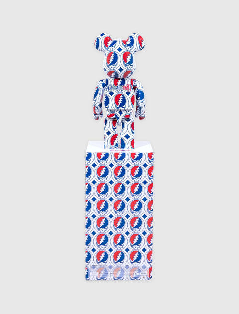 Bearbrick figure with red and blue Grateful Dead lightning bolt pattern, displayed on matching box