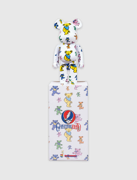Bearbrick collectible toy with colorful dancing bear pattern and Grateful Dead box on gray background