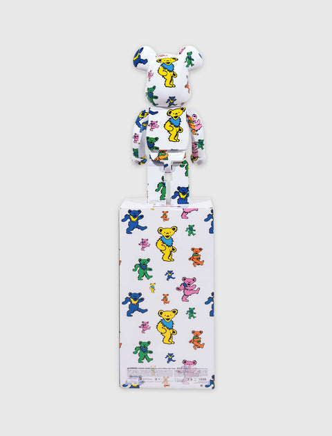 White bear collectible figure with colorful dancing bear print, standing on matching box
