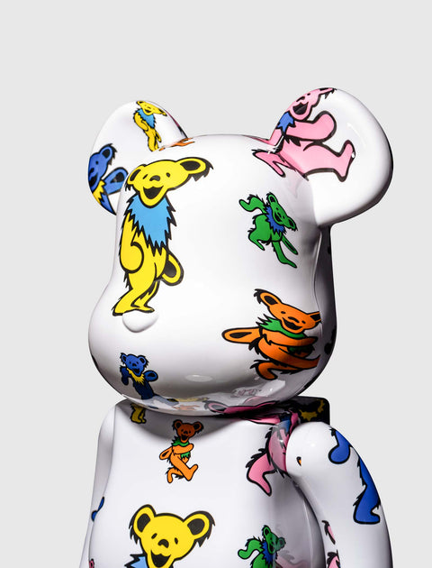 White bear-shaped designer figurine with colorful dancing bear pattern on smooth surface