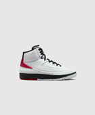 White high-top sneaker with black laces, red accents, and black and white sole on plain background