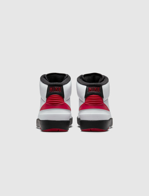 Rear view of white, red, and black high-top sneakers with NIKE logo on heel