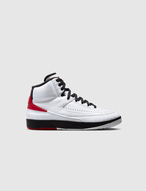 White, black, and red high-top sneaker with textured leather upper and black laces