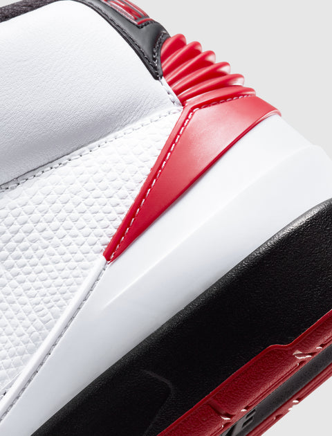 Close-up of white, red, and black textured sneaker heel with geometric details