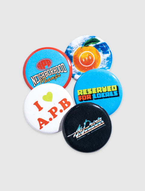 Assorted colorful streetwear-themed buttons on a light gray background