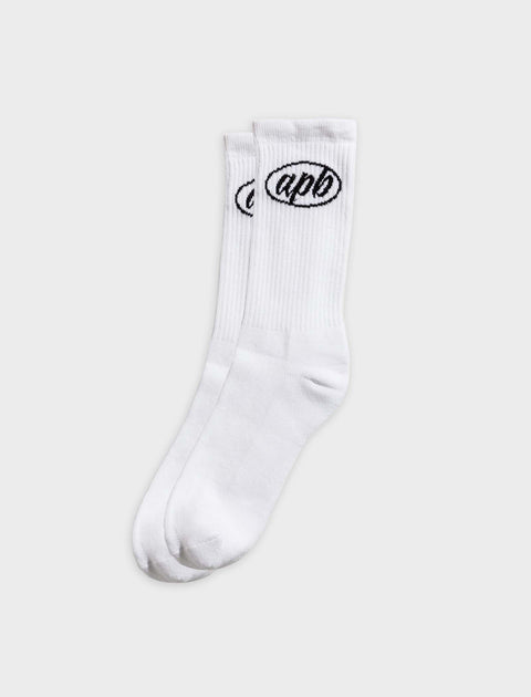 Pair of white crew socks with black oval logo and ribbed texture on a plain background