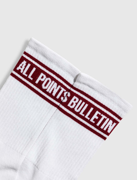 White crew socks with red stripes and 'ALL POINTS BULLETIN' text on the cuff