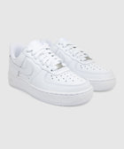 Pair of white leather low-top sneakers with perforated toe and thick rubber sole on gray background