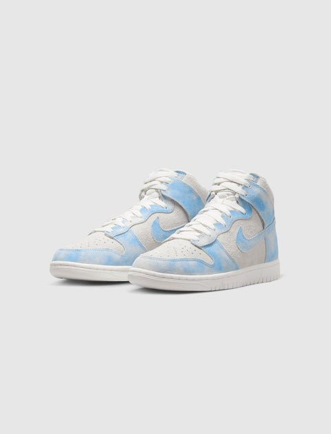 Pair of high-top sneakers with white soles, suede uppers, and blue cloud-like accents