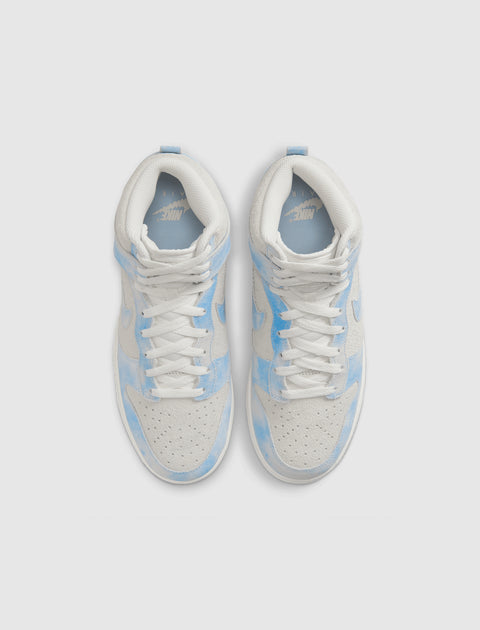Top view of white and light blue suede high-top sneakers with perforated toe box
