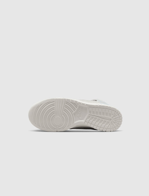 White sneaker outsole with circular tread pattern and Nike logo, flatlay view