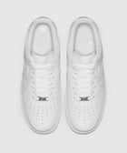 Top view of classic white low-top sneakers with perforated toes and white laces.
