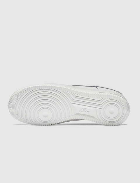 White sneaker outsole with circular grip pattern and textured rubber detailing